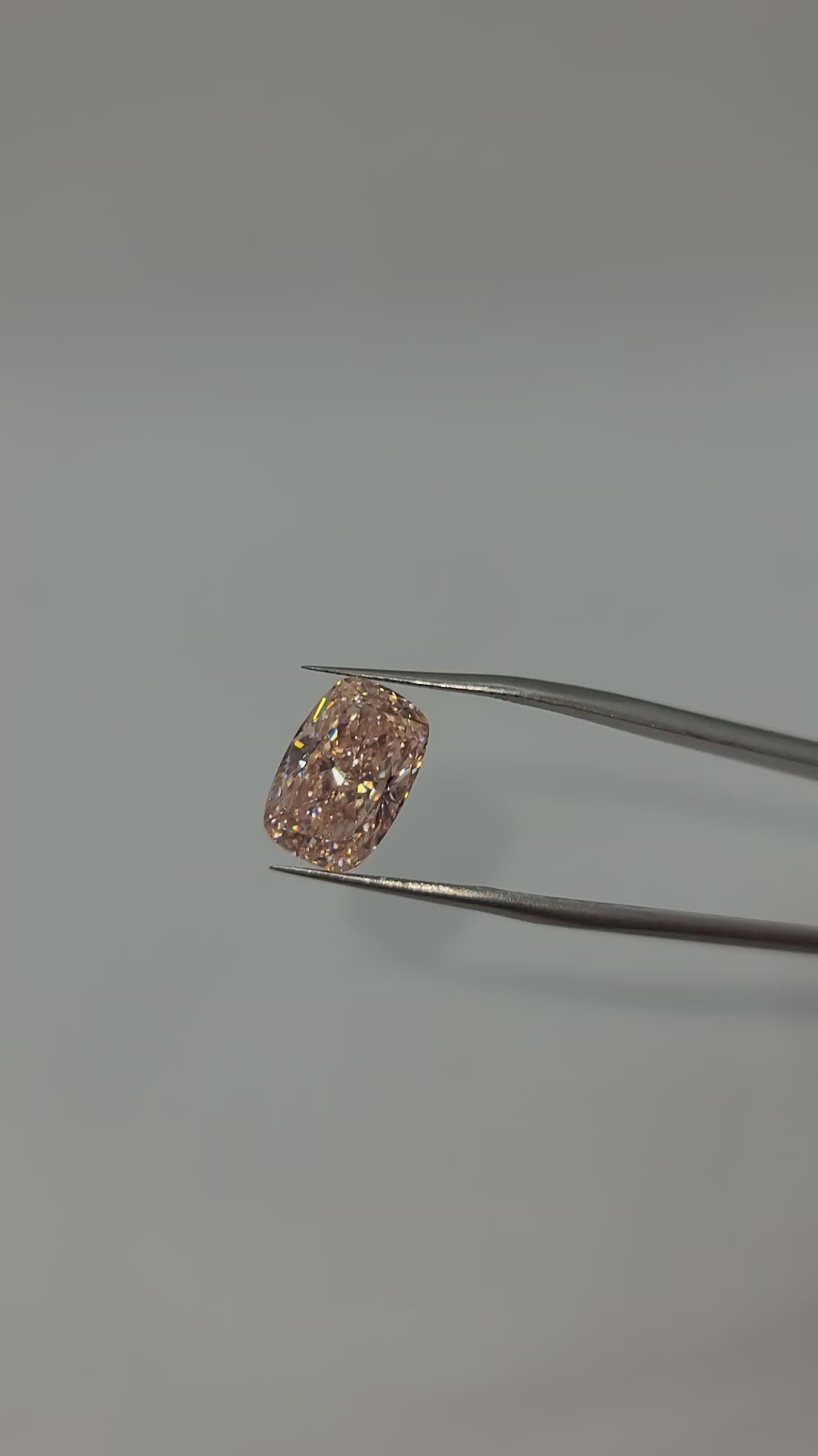 Video of pink lab grown diamond held by tweezers