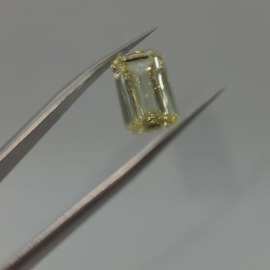 video of yellow lab diamond held in tweezers