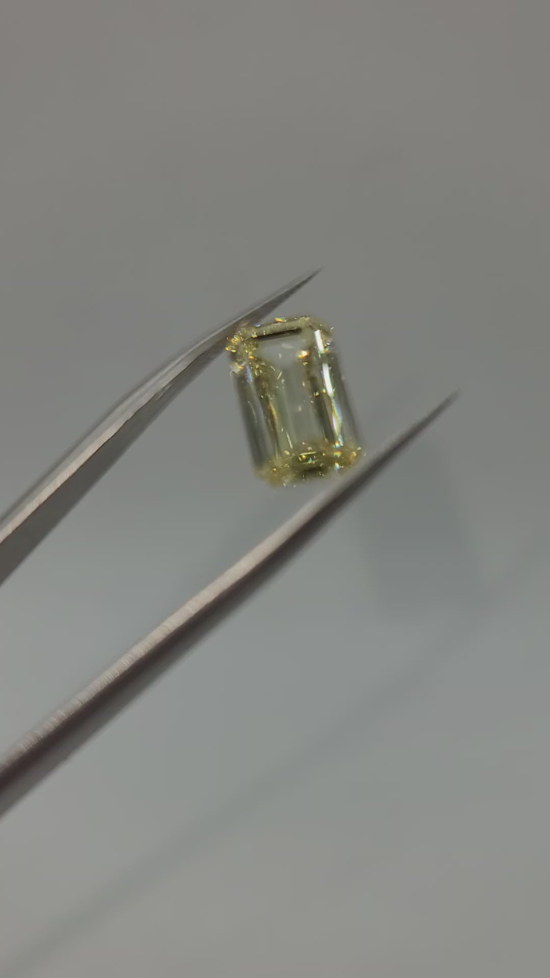 video of yellow lab diamond held in tweezers