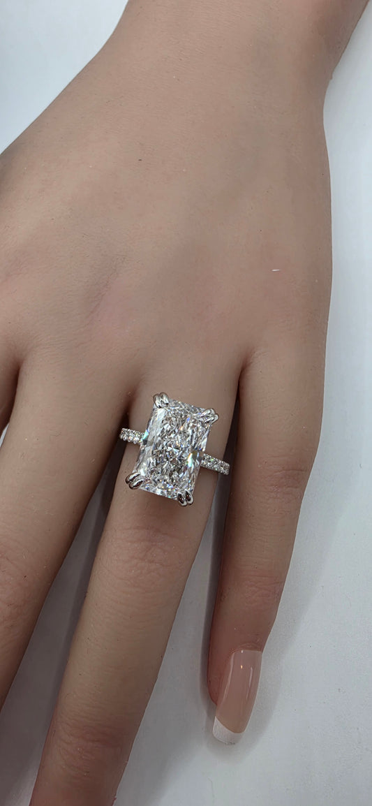 White Gold ring with a diamond on a hand against a white background