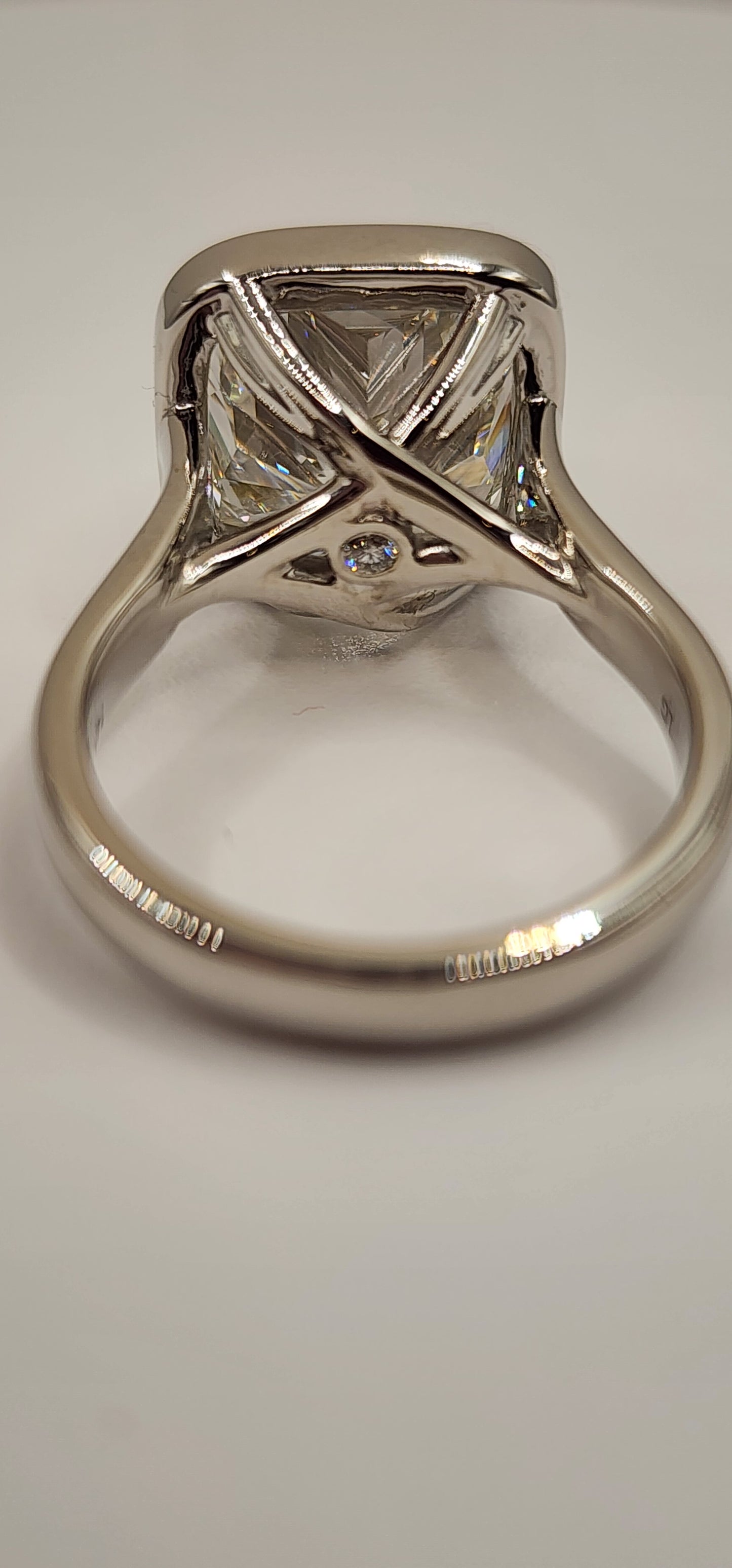 "The Brittney" is a 5.5 Carat Cushion Cut Lab Grown Diamond F/VS1, in a 14k White Gold Full Bezel, Cathedral Setting with Cross Cross Prongs